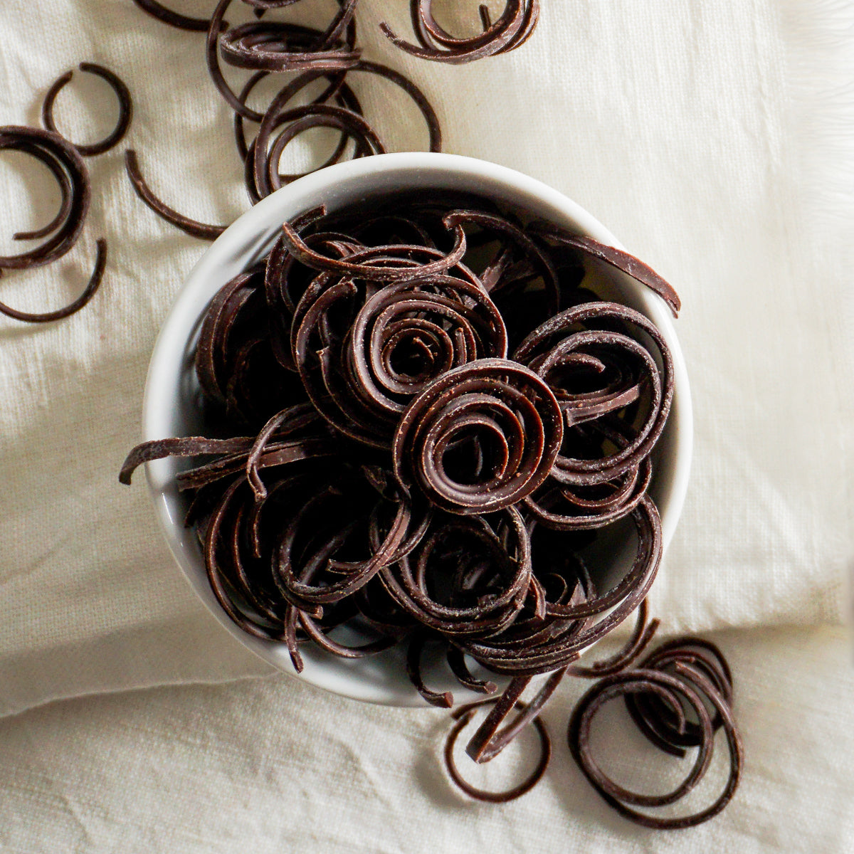 white bowl of dark chocolate spaghetti curls