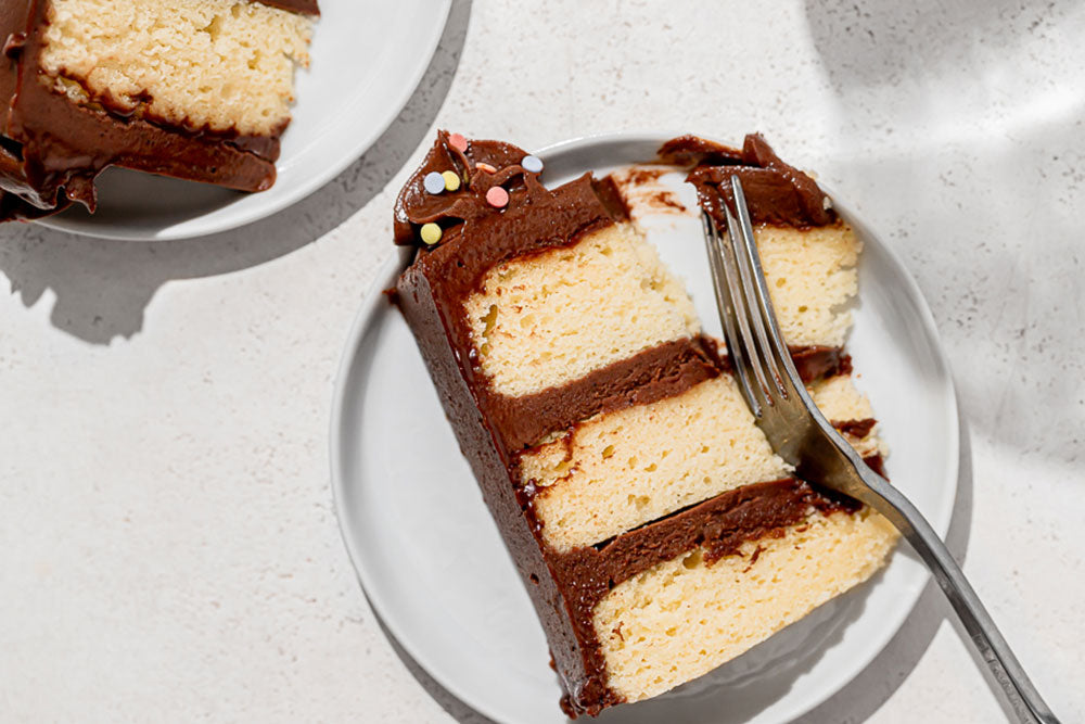 Image of Classic Birthday Cake generously iced in Milk Chocolate Frosting