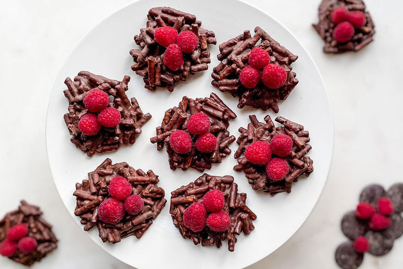 Gluten-free birds nests made with peanut butter, chocolate and raspberries.