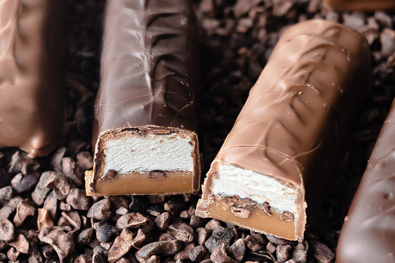 Image of Cocoa Nib Caramel Vanilla Nougat Candy Bars dipped in milk and dark chocolates 