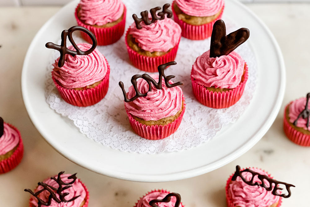 Healthy Holme's Gluten-Free Strawberry Valentine's Day Cupcakes with naturally colored frosting and dark chocolate decorations 
