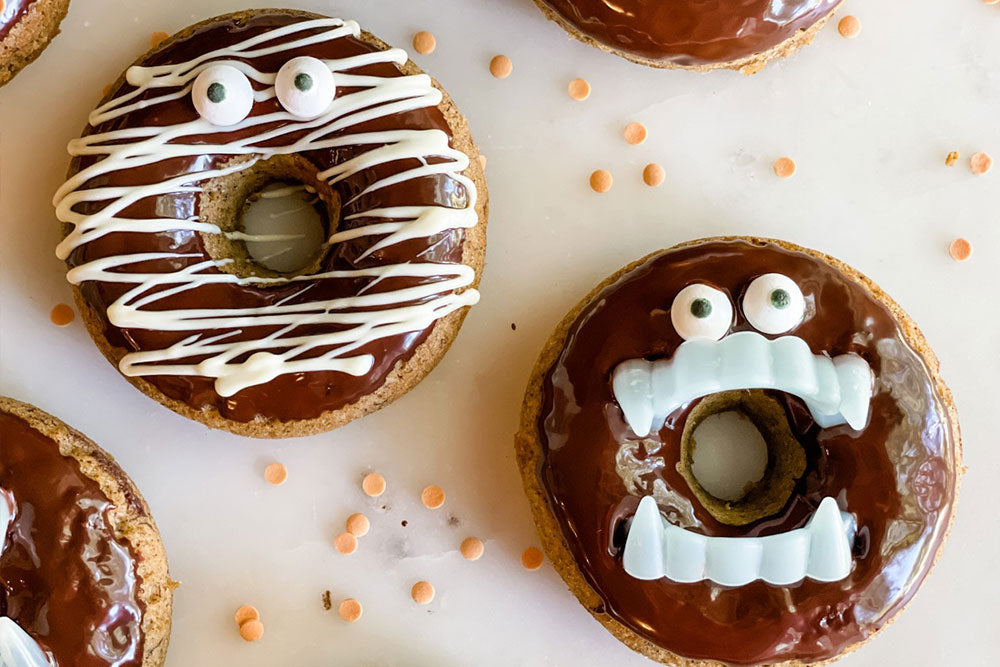 Photo of pumpkin donuts decorated as vampires and mummies