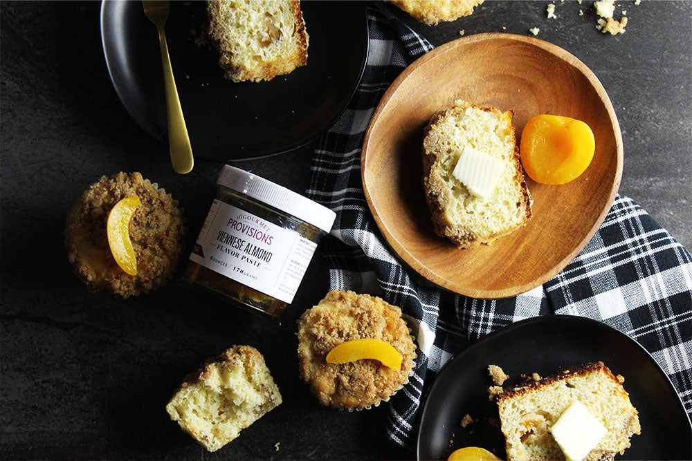 Plates of apricot almond muffins, served with apricots and topped with a cinnamon crumble.