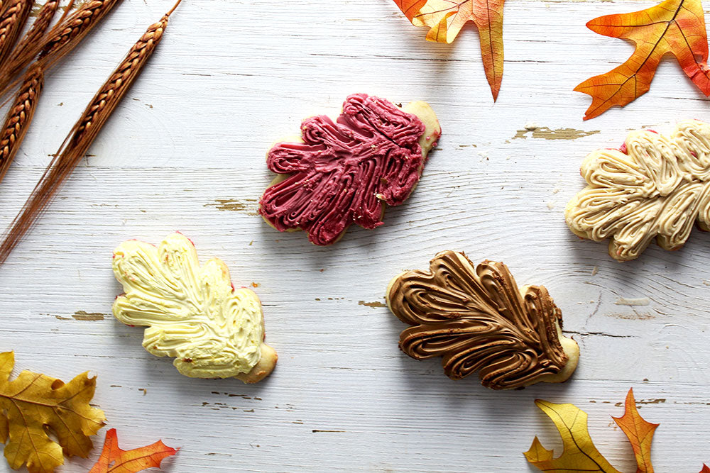 Fall leaf-shaped sugar cookies frosted with colorful flavored buttercream
