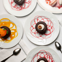 Chocolate Lava Cakes plated with raspberry dessert sauce and mango dessert sauce