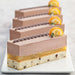 Slices of Layered chocolate and orange flavored mousse, chocolate chip cheesecake and orange gelee 